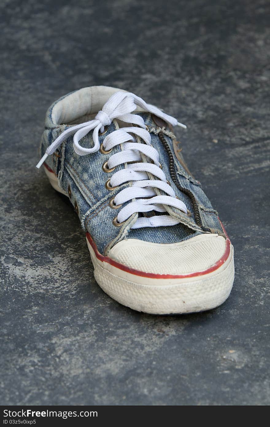 Old jean sneaker on concreate