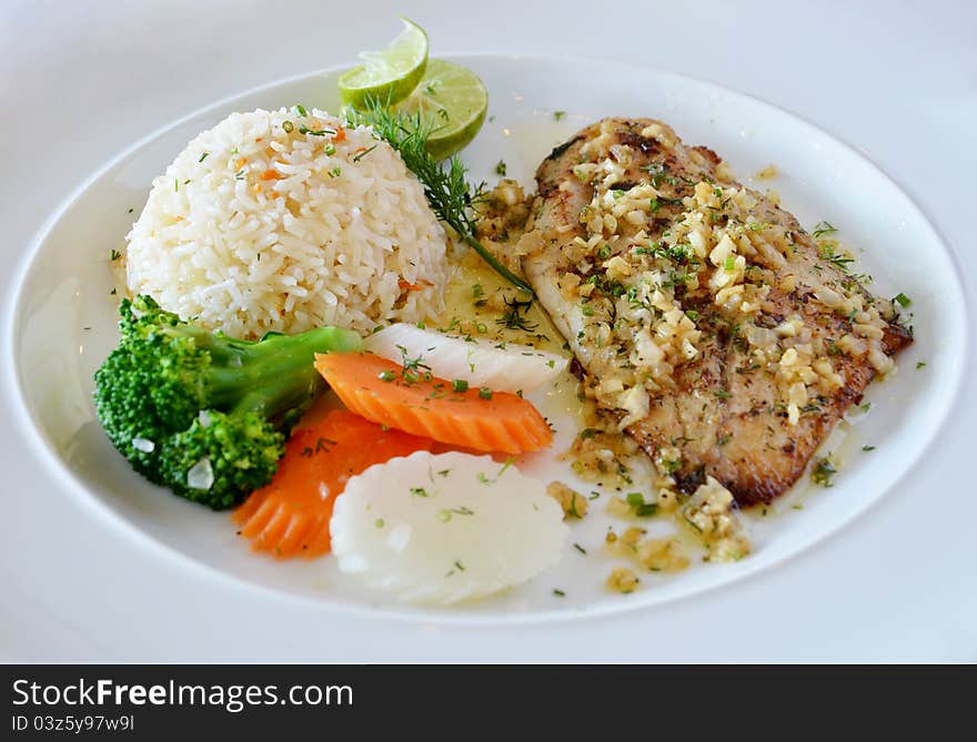 Roasted fish served with fried rice. Roasted fish served with fried rice