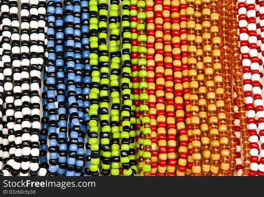 Different coloured glass beads hanging in a row