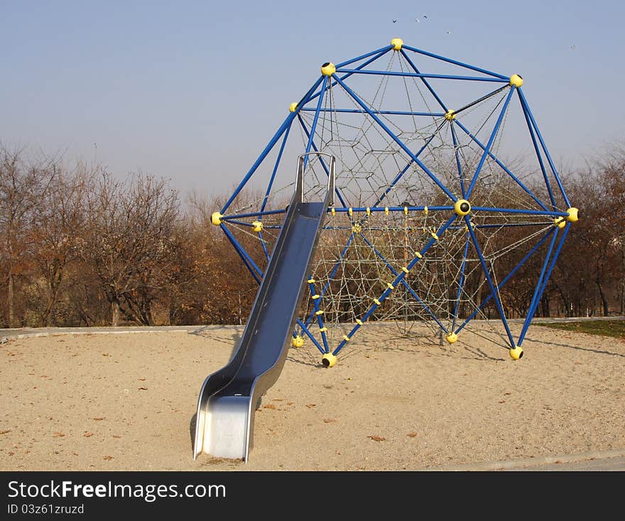 Special children climbing playground in a park. Special children climbing playground in a park