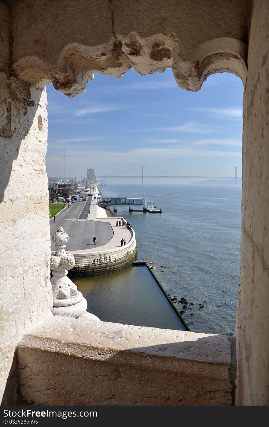 This is the view from the belem tower (Torre de Belem ) in Lisbon, portugal. The river Tejo together with the april the 25th bridge and the monument to the discoveries can be seen. This is the view from the belem tower (Torre de Belem ) in Lisbon, portugal. The river Tejo together with the april the 25th bridge and the monument to the discoveries can be seen