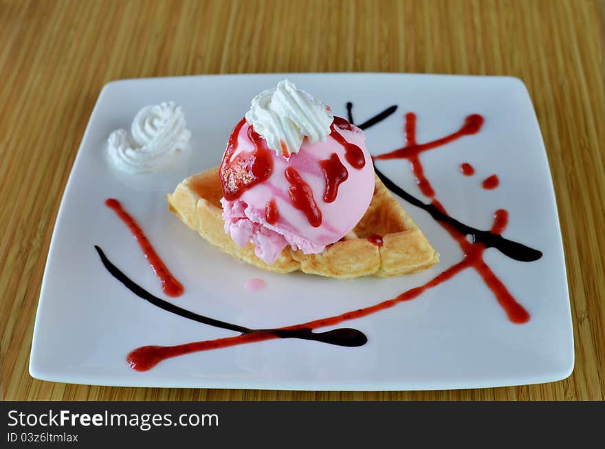 Waffle and whipping cream with strawberry ice cream. Waffle and whipping cream with strawberry ice cream