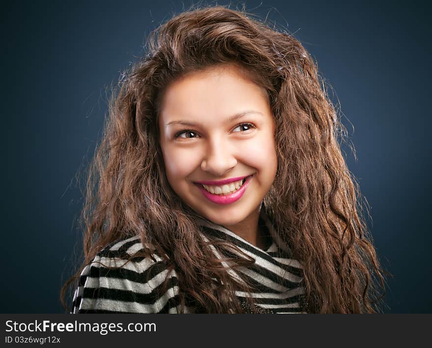 Portrait of beautiful smiling girl  on blue background