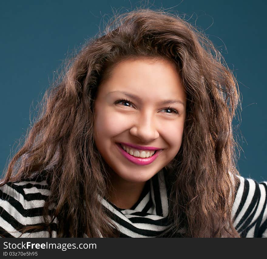 Portrait of beautiful smiling girl  on blue background