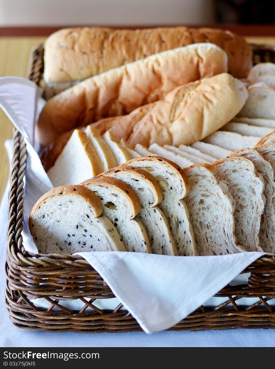 Arrangement of bread in basket on table. Arrangement of bread in basket on table