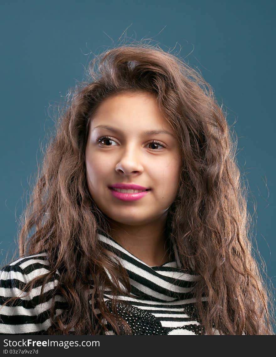 Portrait of beautiful smiling girl isolated on blue background