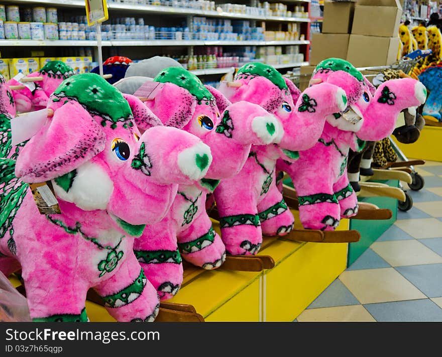 Soft toy - a pink elephant on a supermarket counter