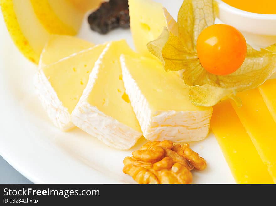 Bites of different cheeses with honey  and nuts. Bites of different cheeses with honey  and nuts