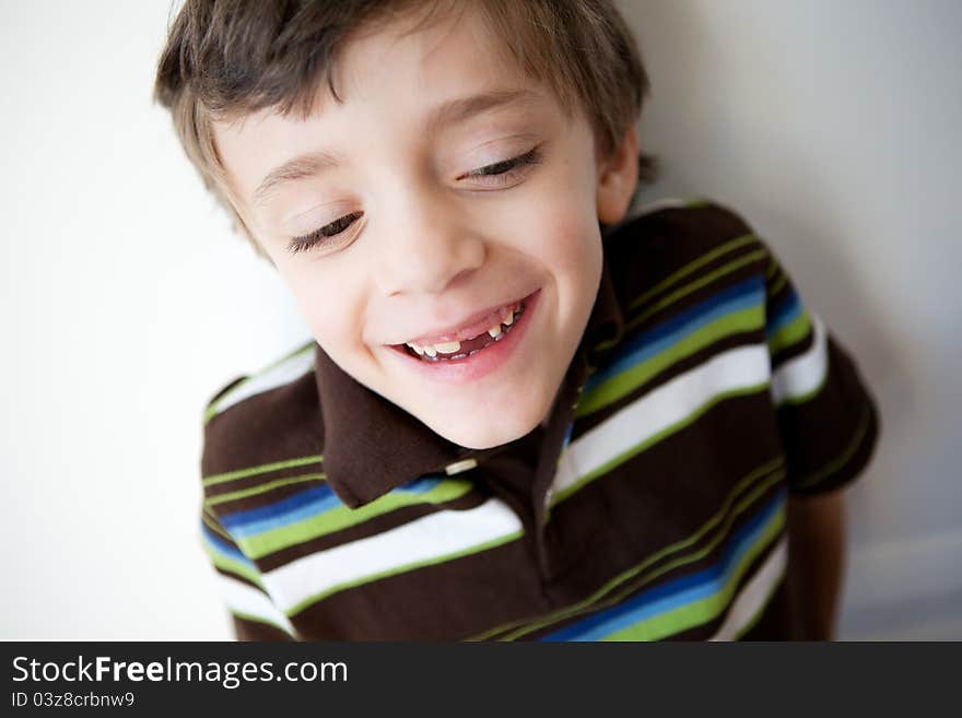 Laughing boy showing missing front tooth
