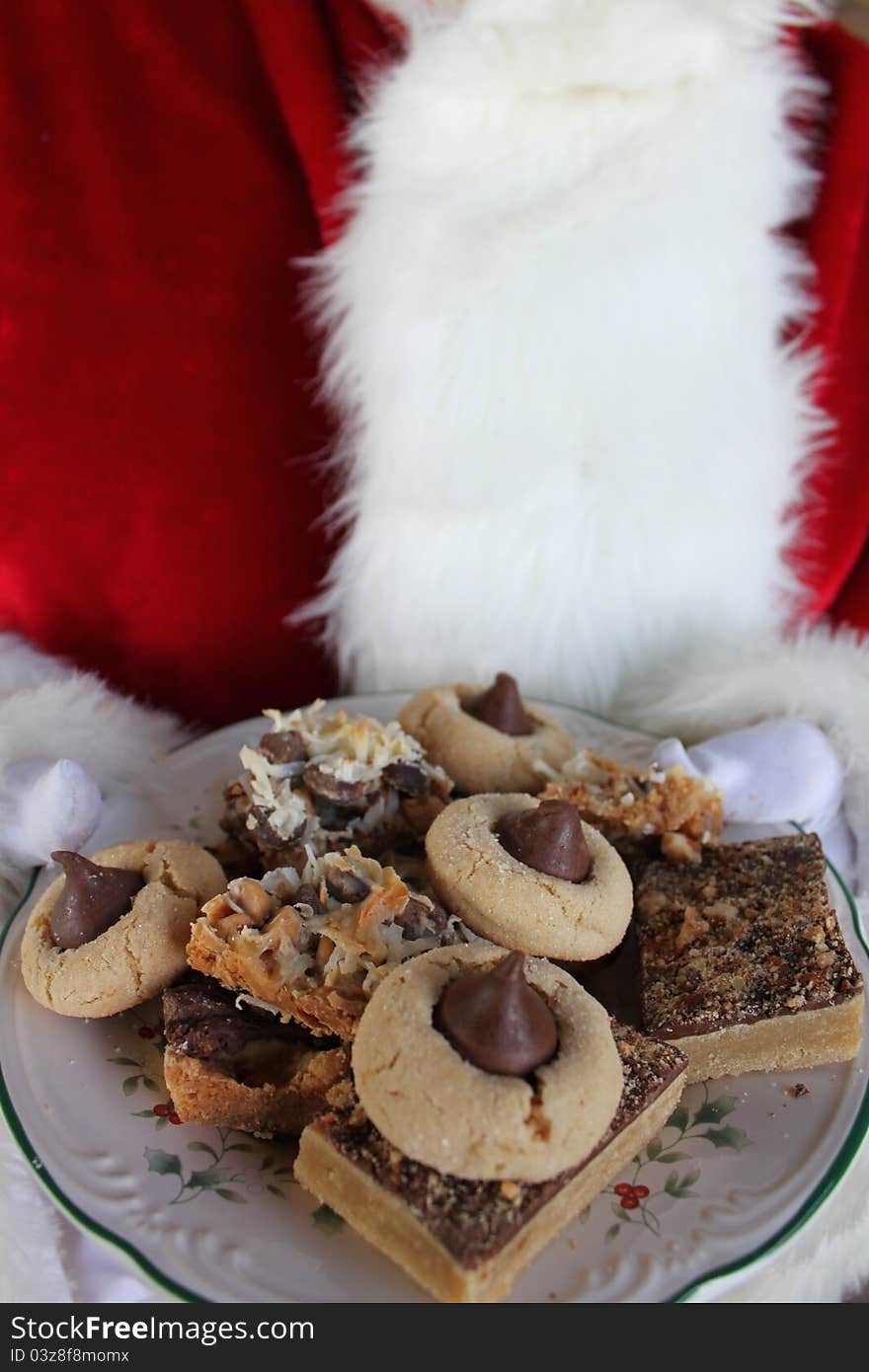 Santa Claus holding a plate of Christmas cookies. Santa Claus holding a plate of Christmas cookies.