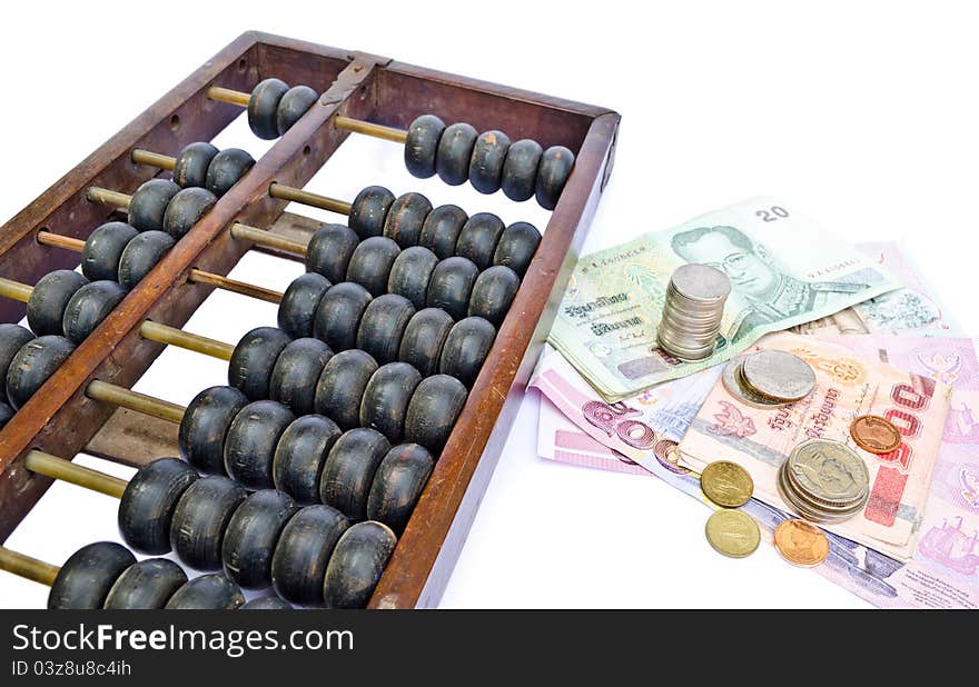 Old abacus and many kind of Thailand's money on white background. Old abacus and many kind of Thailand's money on white background