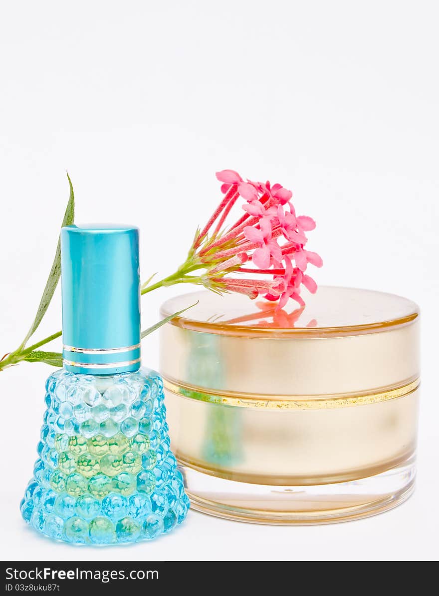 Blue perfume bottle and powder with flower on white background. Blue perfume bottle and powder with flower on white background