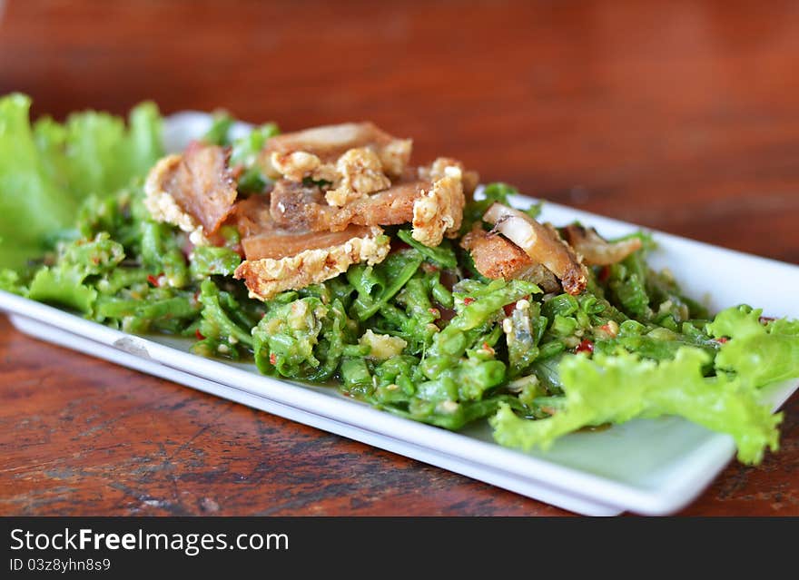 String bean spicy salad served with crispy pork. String bean spicy salad served with crispy pork