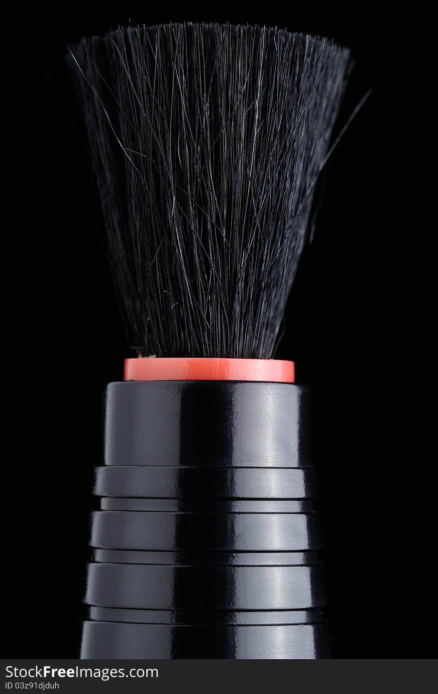 A lens brush on a black background