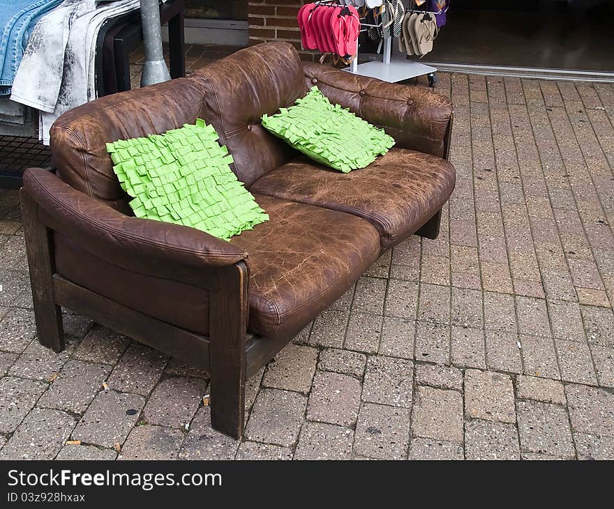 Abandoned old leather sofa laid in a city street. Abandoned old leather sofa laid in a city street