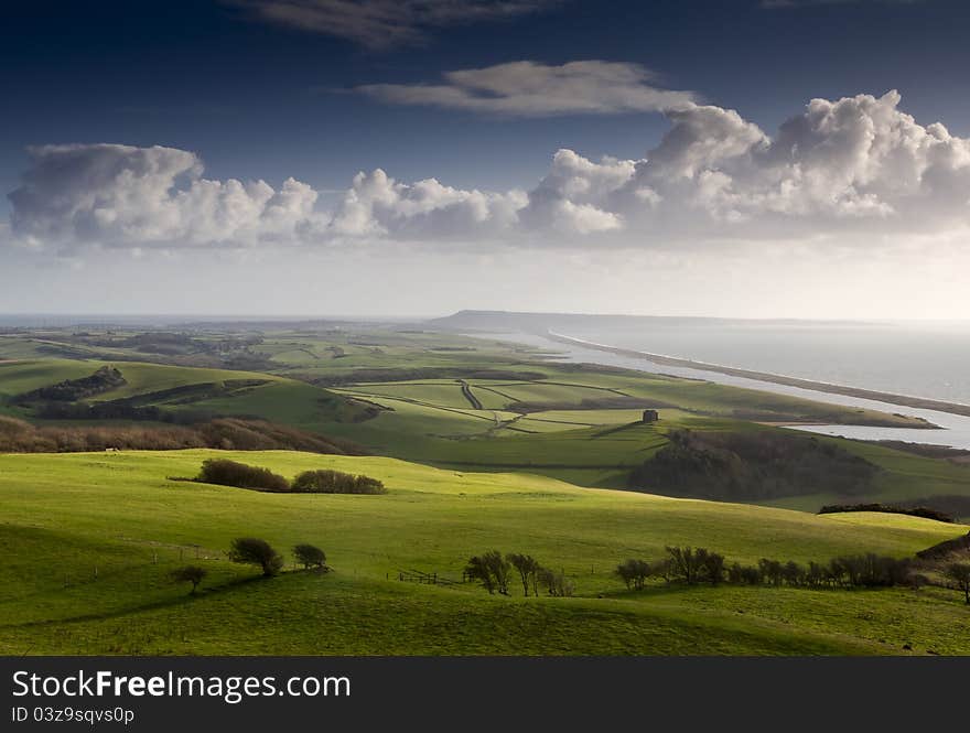 View of Chesil Beach with historic St Catherine's Chapel and Portland in the distance. View of Chesil Beach with historic St Catherine's Chapel and Portland in the distance