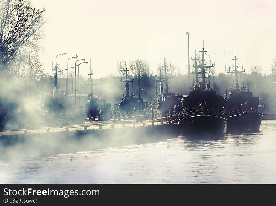 Group of millitary ships on harbour