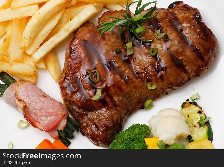 Garnished plate of grilled steak meat