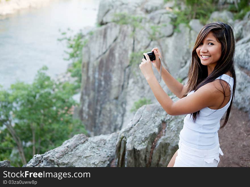 Woman photographing scenic river