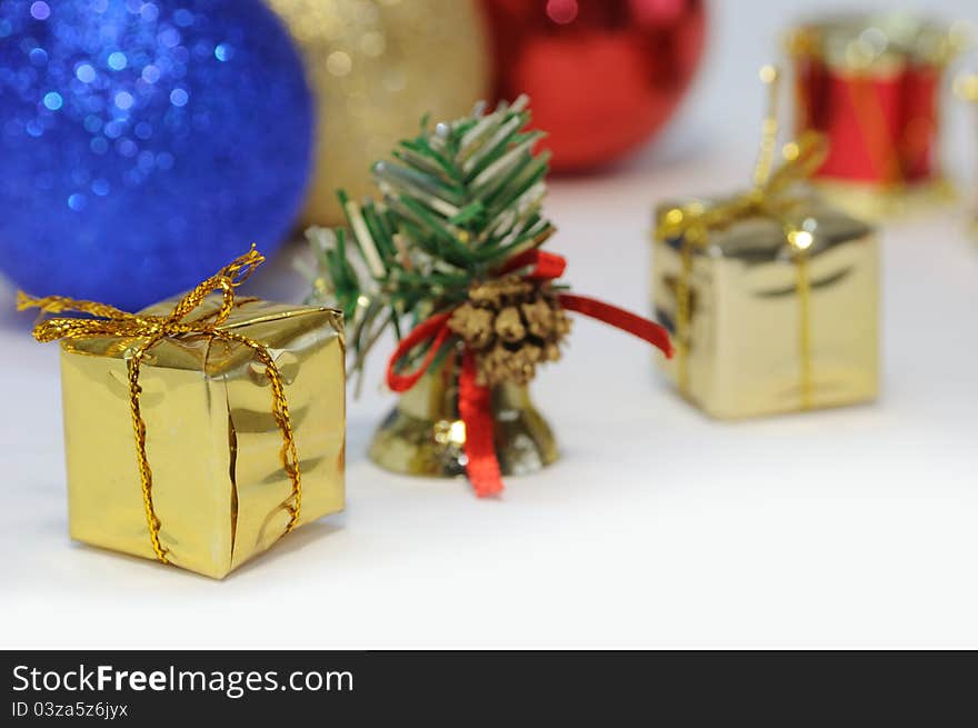 Colorful christmas decoration with little golden gift box