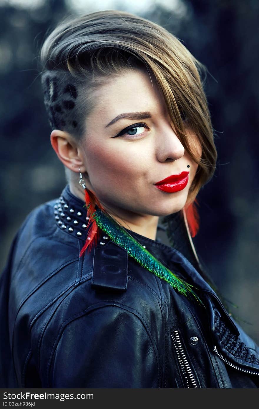 Blond hipster girl with leopard haircut alone outdoors in autumn