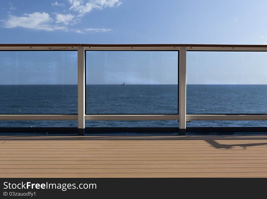 A ocean view from a boat thru the safety rail. A ocean view from a boat thru the safety rail