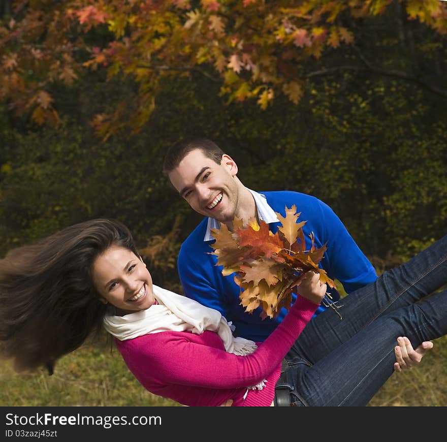 Young men carrying his girlfriend in his arms. Young men carrying his girlfriend in his arms