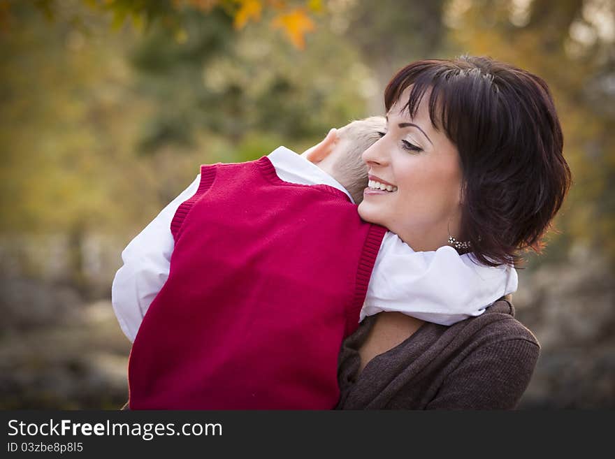 Attractive Mother and Cute Son Portrait Outside at the Park. Attractive Mother and Cute Son Portrait Outside at the Park.