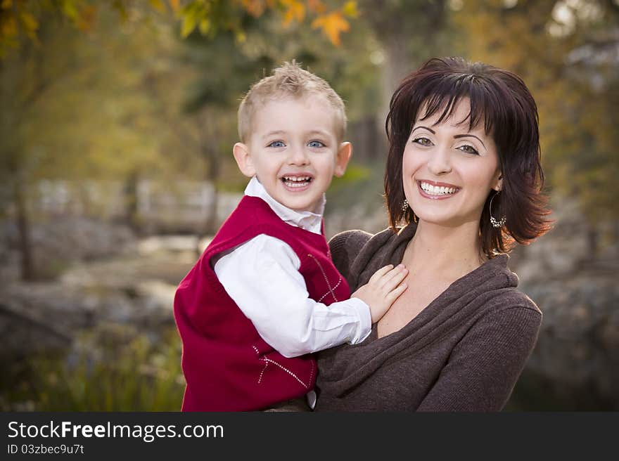 Attractive Mother and Cute Son Portrait Outside at the Park. Attractive Mother and Cute Son Portrait Outside at the Park.