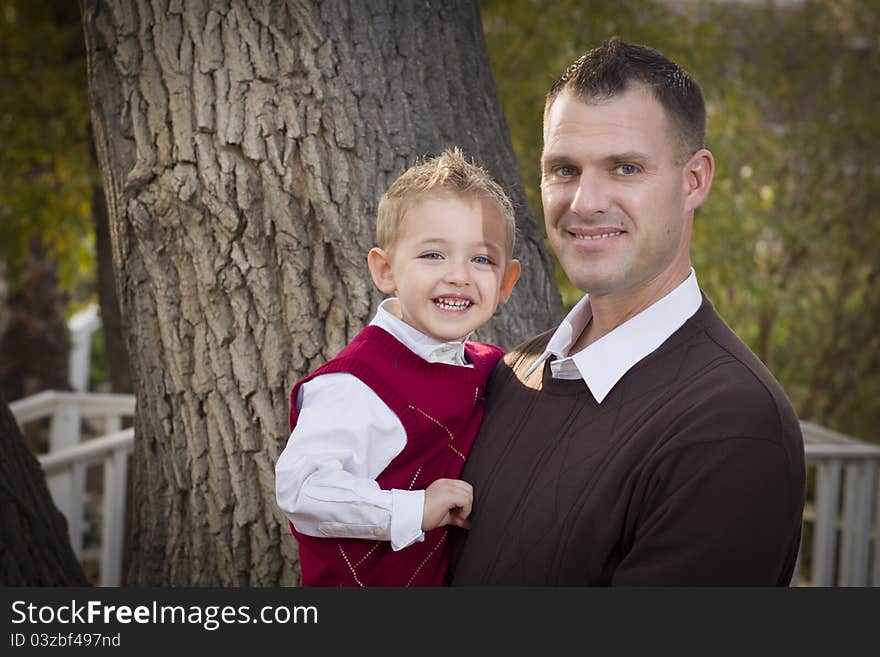 Handsome Father and Son Having Fun in the Park. Handsome Father and Son Having Fun in the Park.