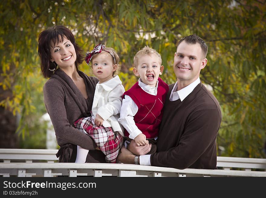 Young Attractive Parents and Children Portrait Outside in the Park. Young Attractive Parents and Children Portrait Outside in the Park.