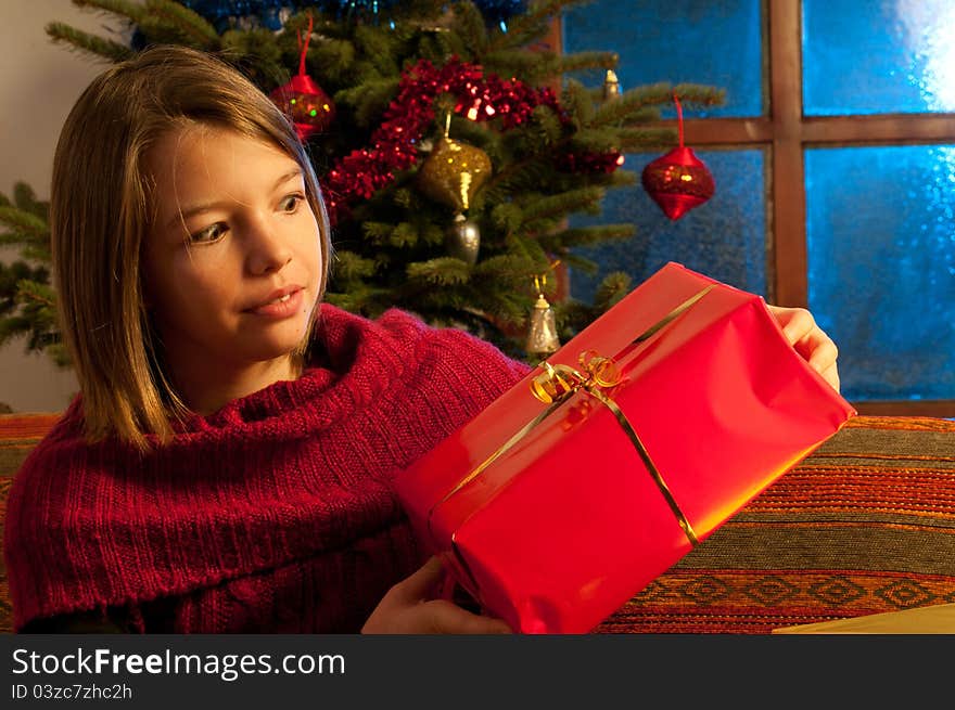 Surprised Girl  Studying Christmas Gift