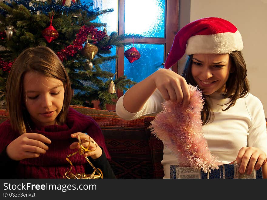 Two white girls having fun with christmas gifts. Two white girls having fun with christmas gifts