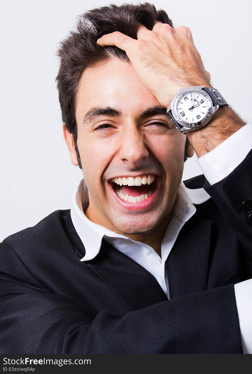 Attractive young businessman laughing before the camera. Attractive young businessman laughing before the camera