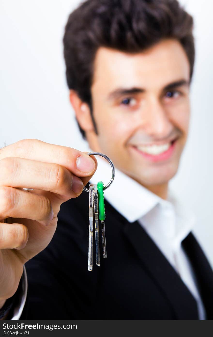 Attractive young seller showing a house key to the camera. Attractive young seller showing a house key to the camera