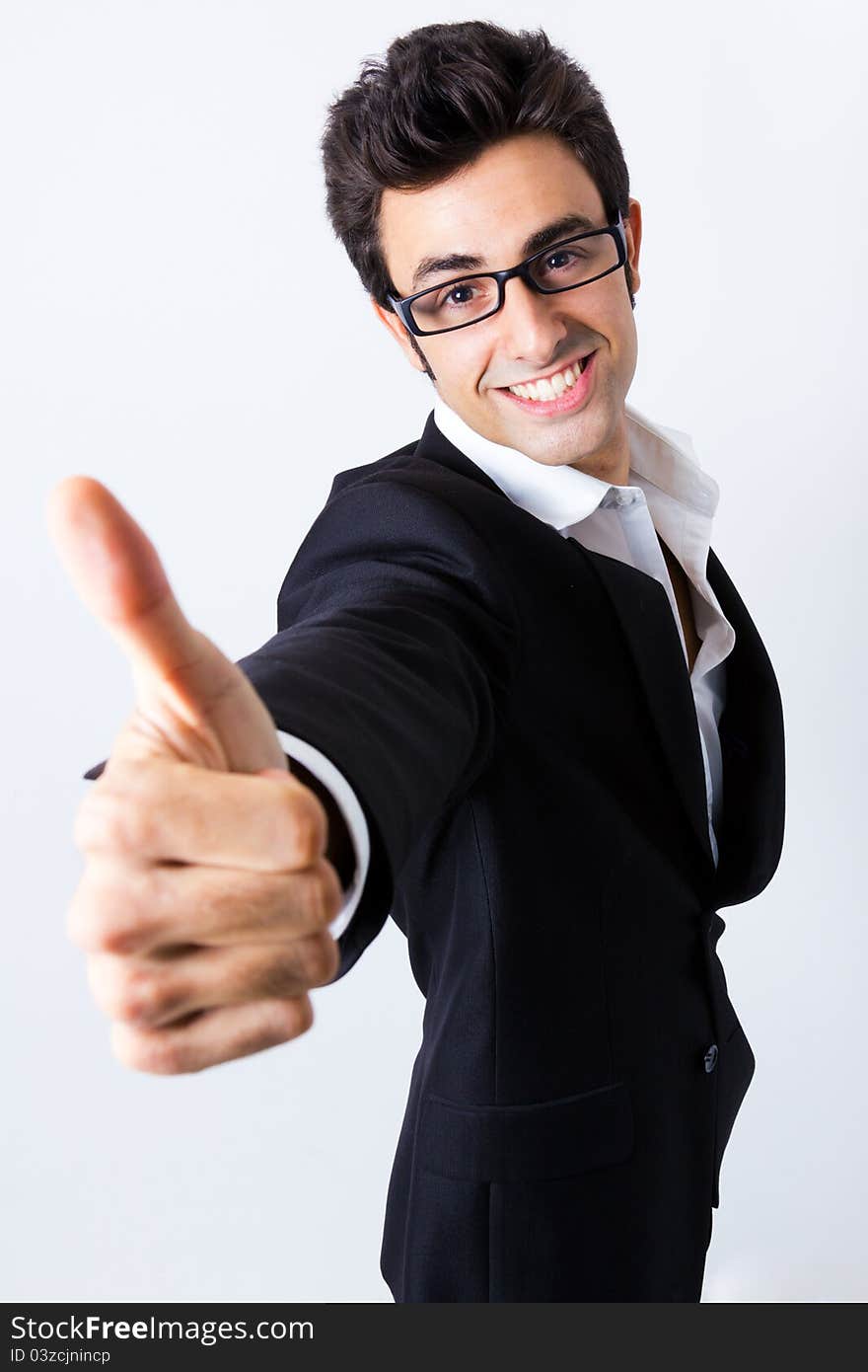 Portrait of attractive young businessman making the sign of Ok to the camera. Portrait of attractive young businessman making the sign of Ok to the camera