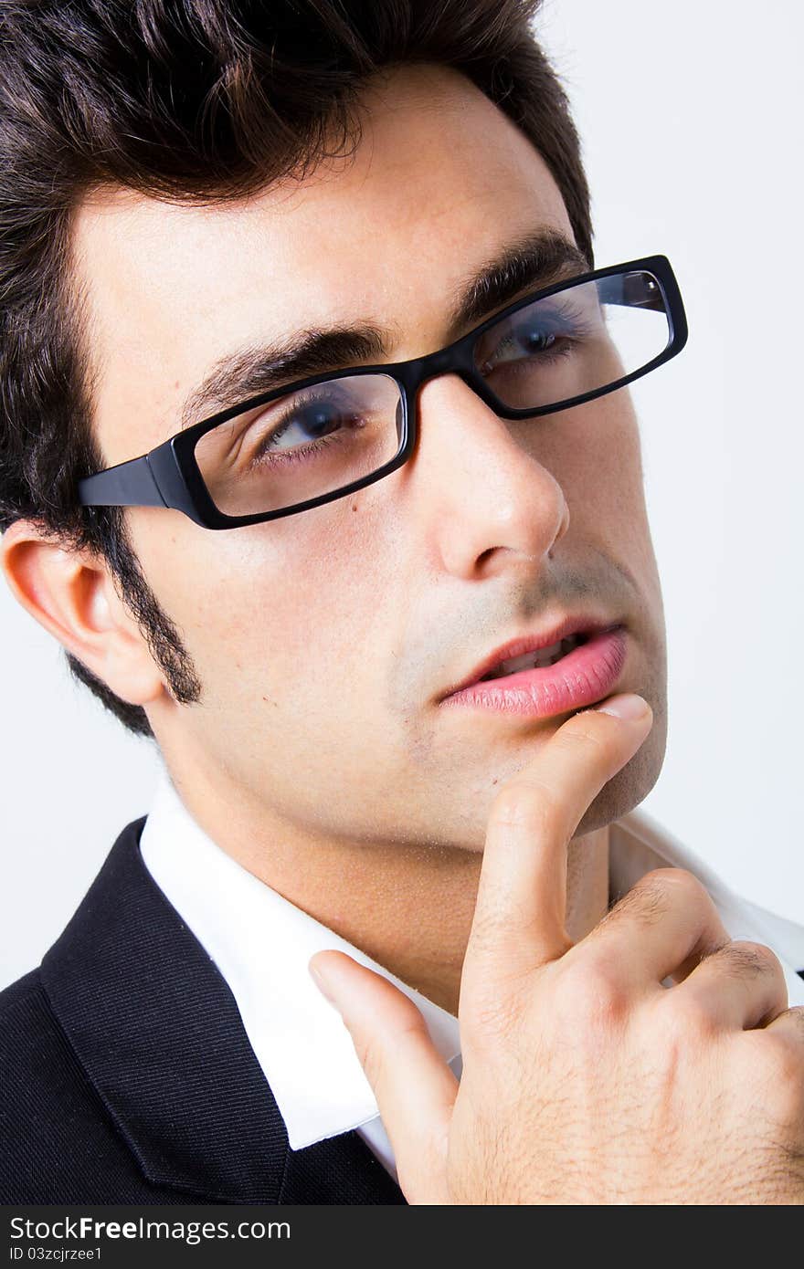 Attractive young businessman with his glasses, thinking. Attractive young businessman with his glasses, thinking