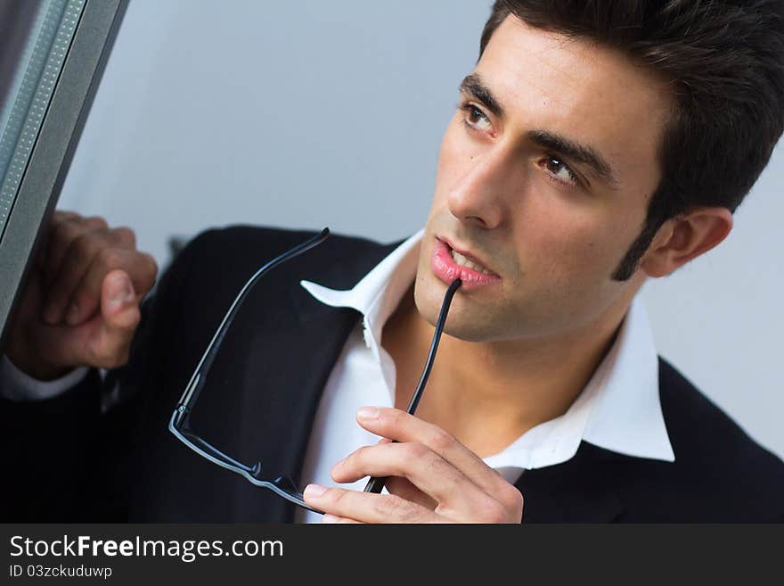 Portrait of attractive young businessman thinking. Portrait of attractive young businessman thinking