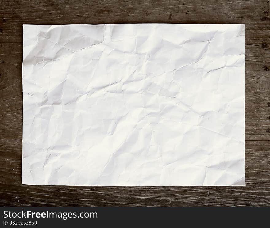 Crumpled Paper On Wooden Background