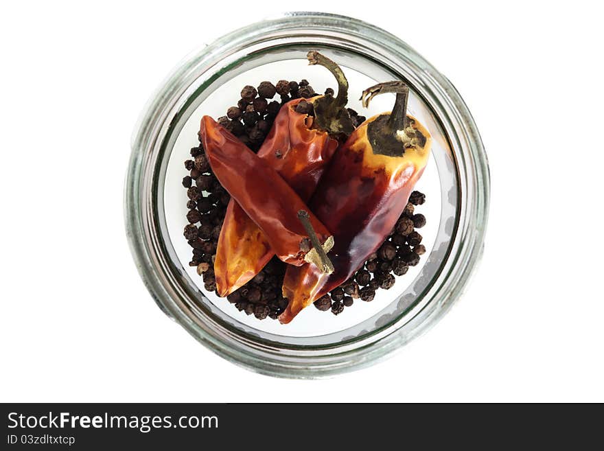 Dried red chilis pepper in a glass jar on a white background. Dried red chilis pepper in a glass jar on a white background