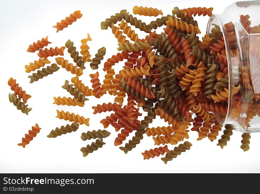 Dried pasta in a glass jar on white background. Dried pasta in a glass jar on white background