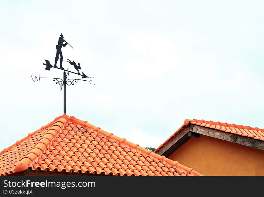 Black Compass wind on red roof. Black Compass wind on red roof