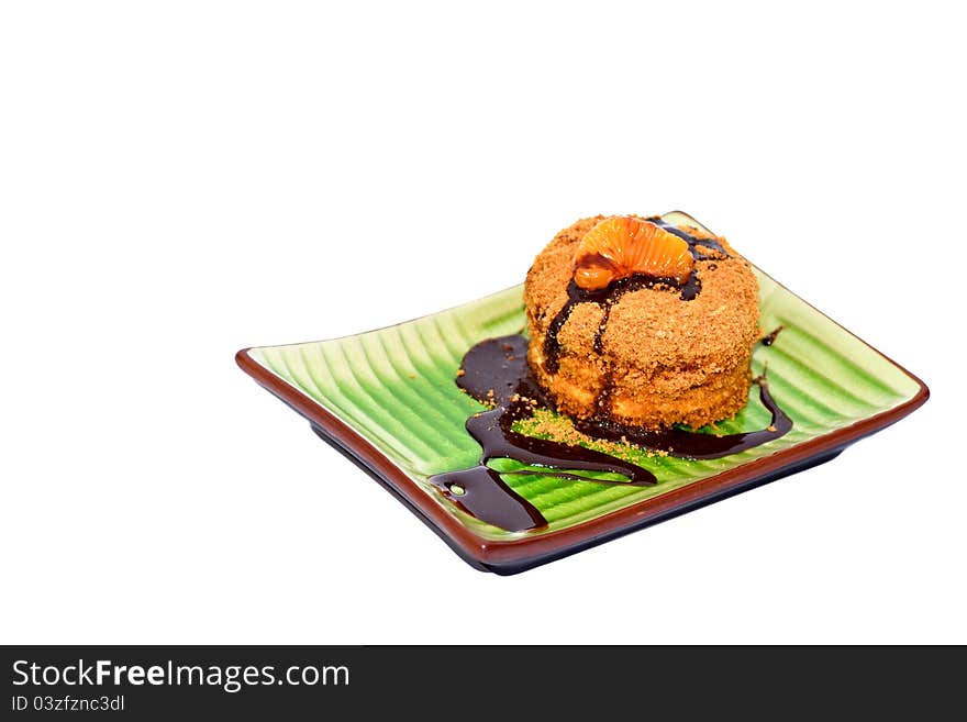 Slice of honey cake with chocolate on white background