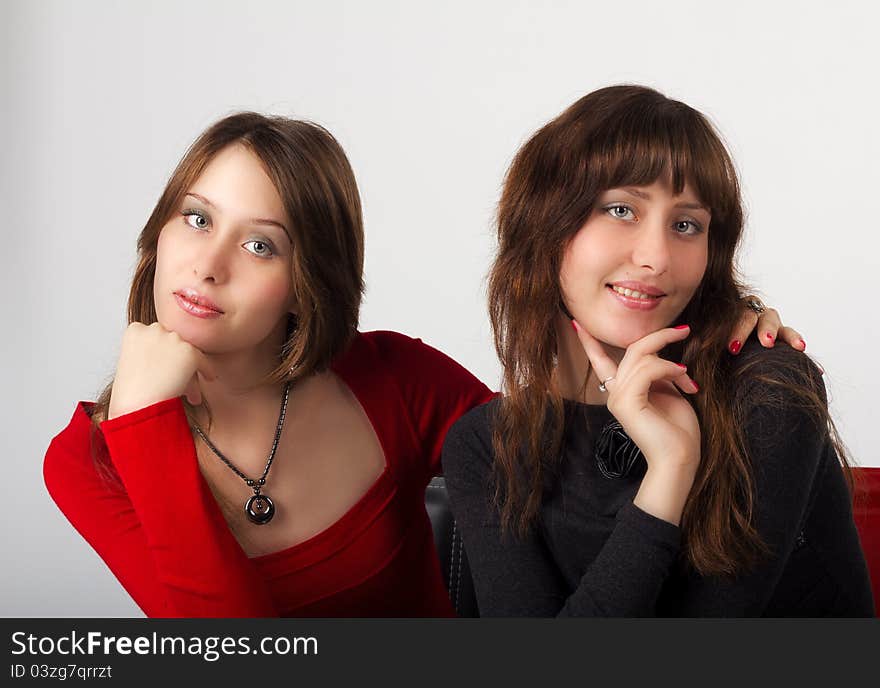 Portrait of young pretty sisters twins