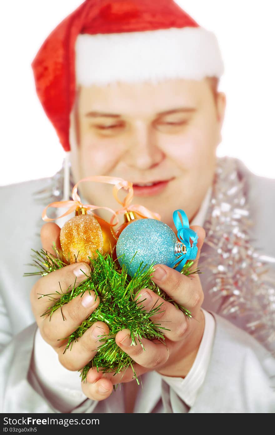 Young man holds Christmas toys. on white background.Soft focus.