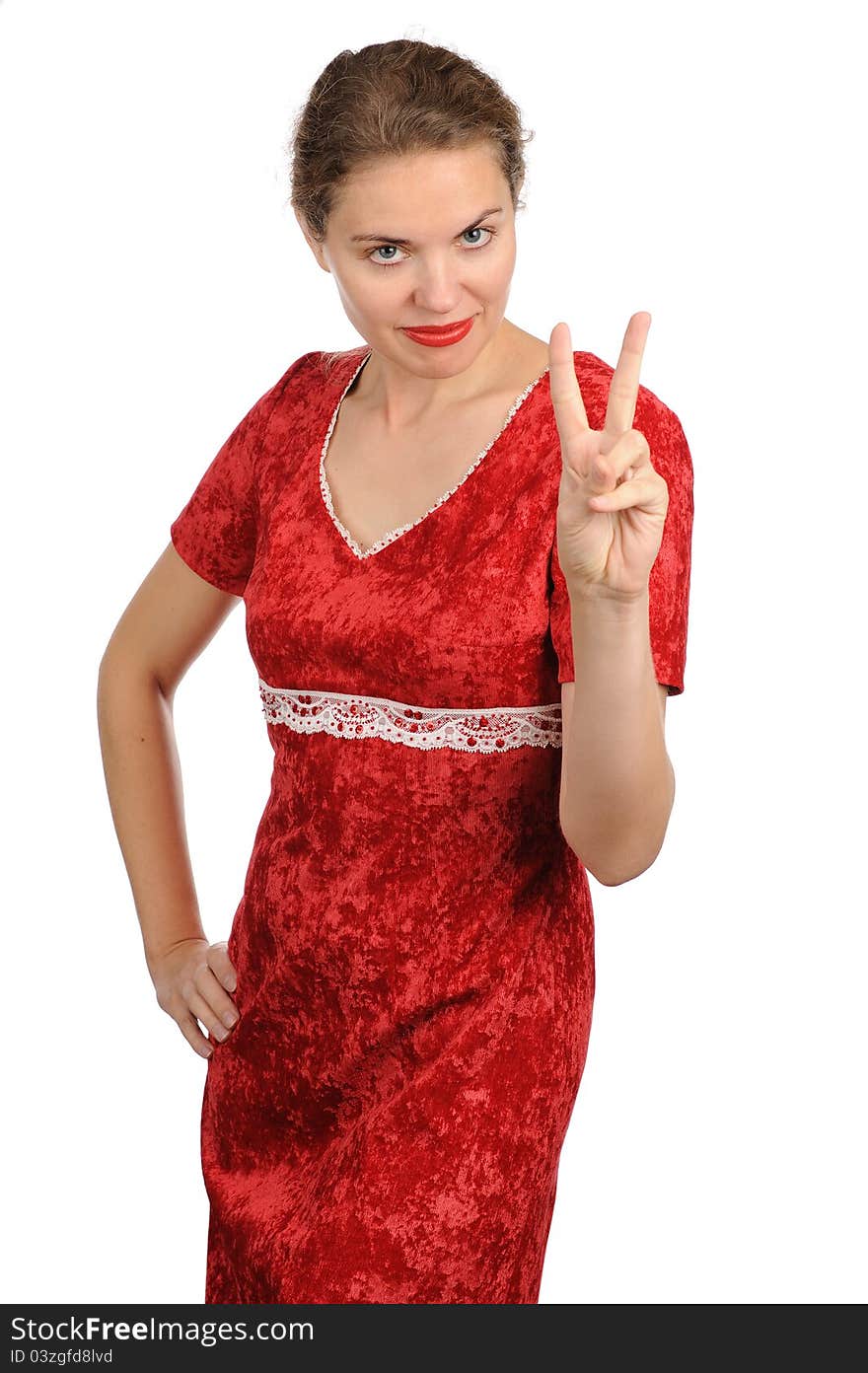 The woman in a red dress showing two fingers of a hand. The woman in a red dress showing two fingers of a hand