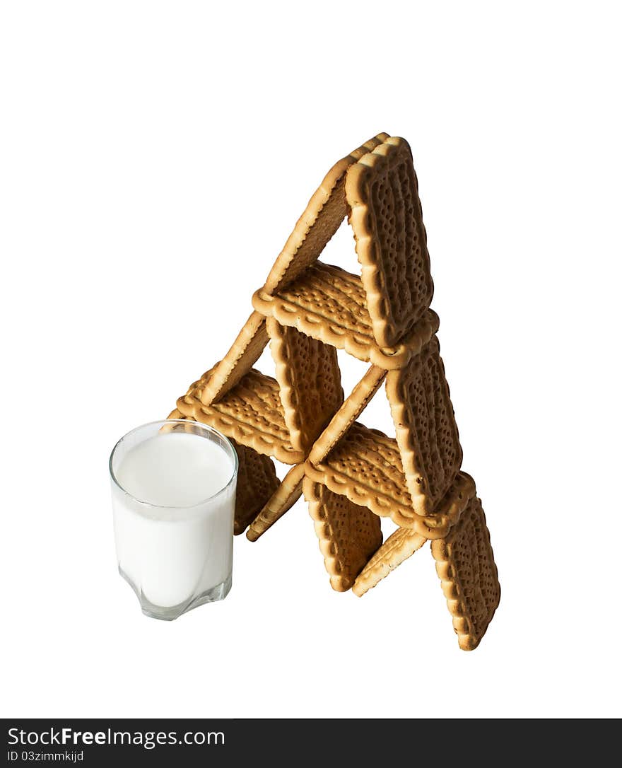 House of cookies and a glass of milk isolated on white background