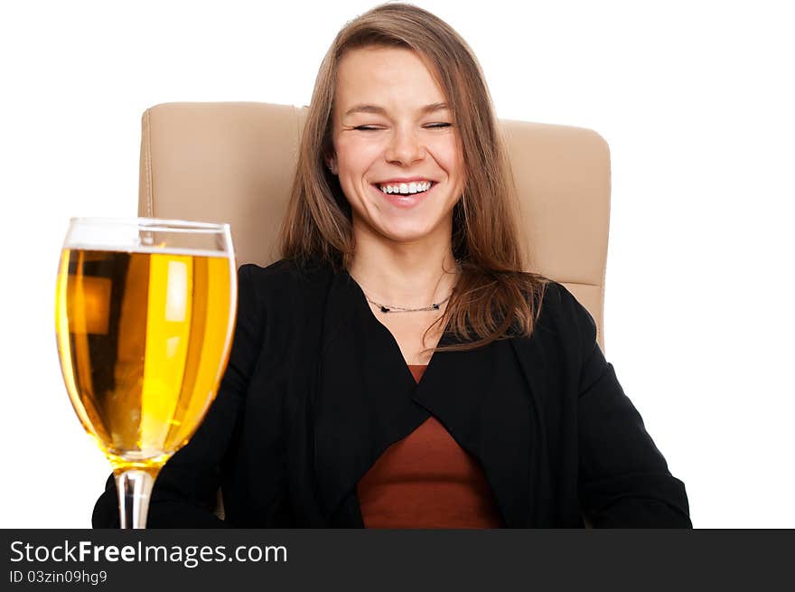 Businesswoman in leather chair with glass of cider laughing isolated on white