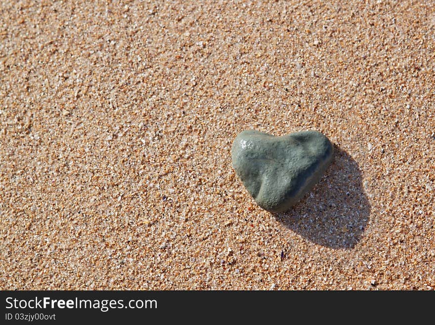 Stone in the shape of a heart on the beach.