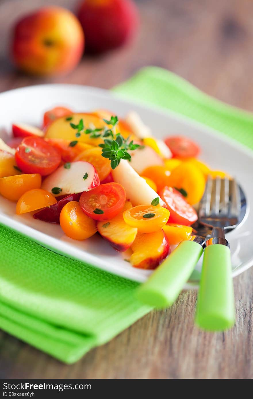 Peaches, nectarines, tomatoes and thyme salad, selective focus